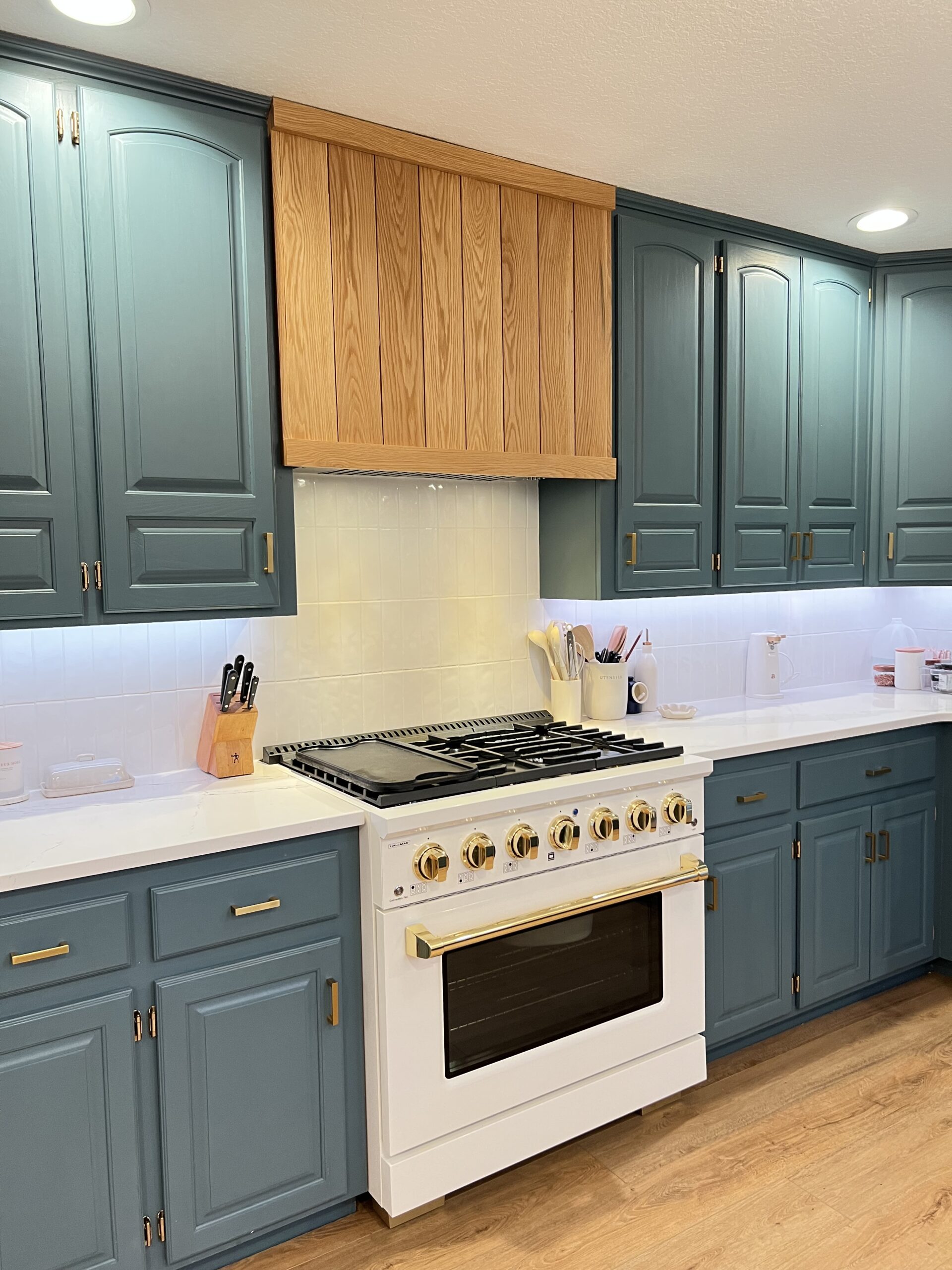 white freestanding range with brass accents